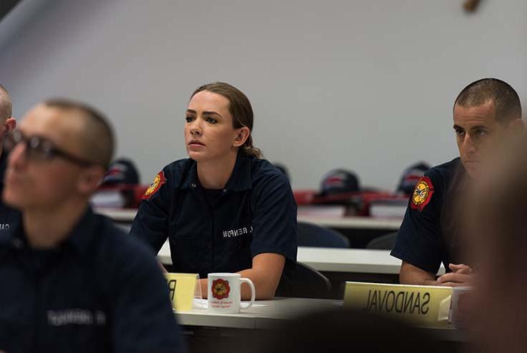 Female student in firefighter training class