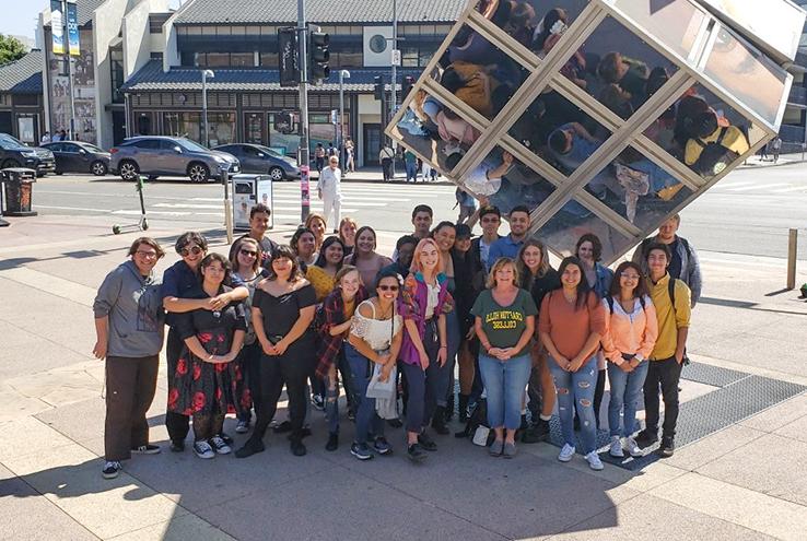 Students next to sculpture